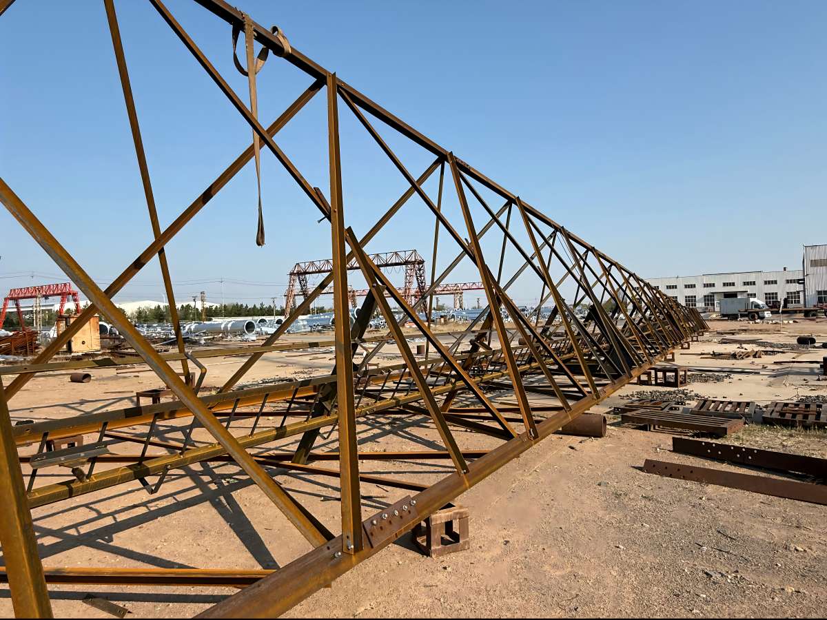 Испытательная сборка 60-метровой трехопорной телекоммуникационной вышки из угловой стали перед оцинковкой.